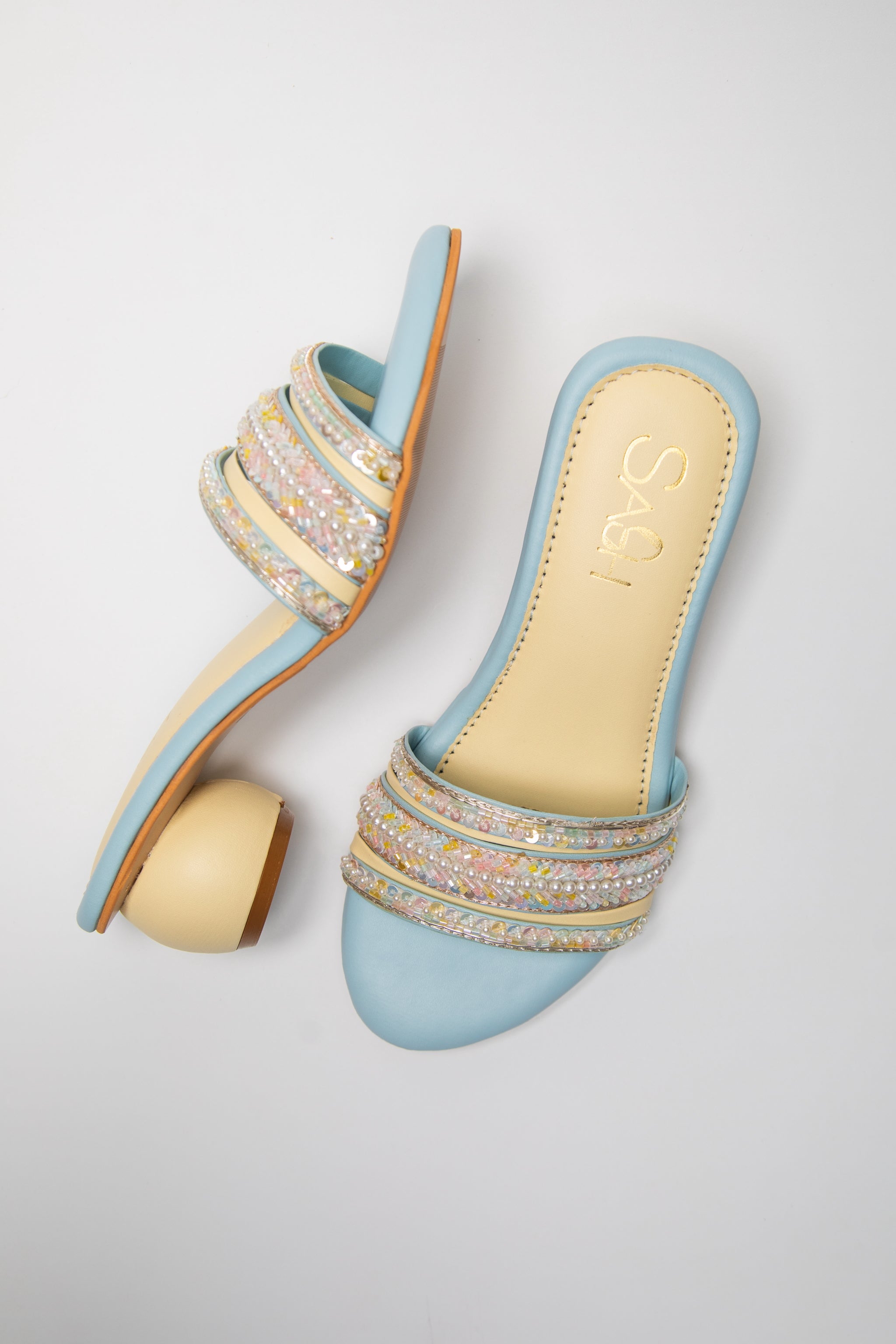 Powder Blue round 2 inch heels with slide straps of intrictae pastel pink, yellow and blue handwork with pearls