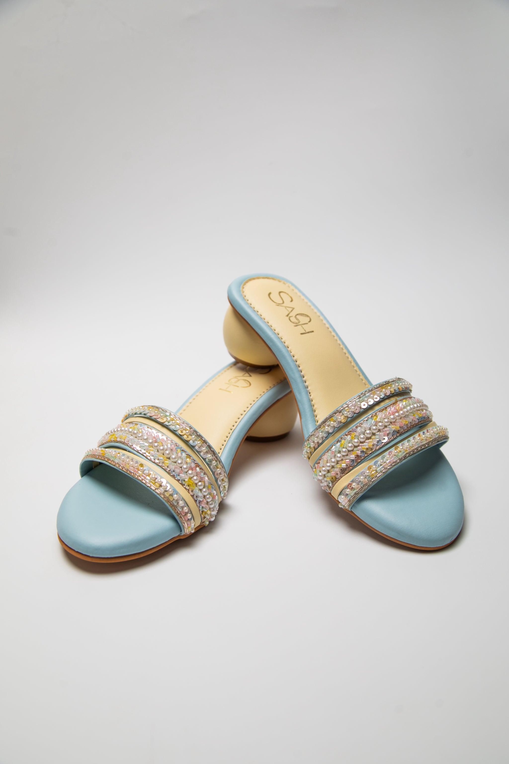 Powder Blue round 2 inch heels with slide straps of intrictae pastel pink, yellow and blue handwork with pearls